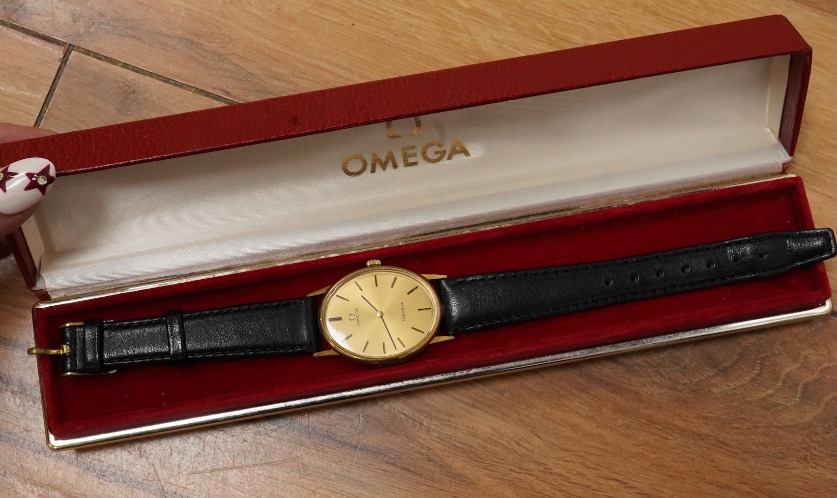 A lady's early 1970's steel and gold plated Omega manual wind wrist watch, with oval dial and baton numerals, case diameter 26mm, movement c.620, on an associated leather strap, with box no papers.